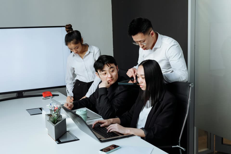 Professionals planning local visibility improvements around a laptop